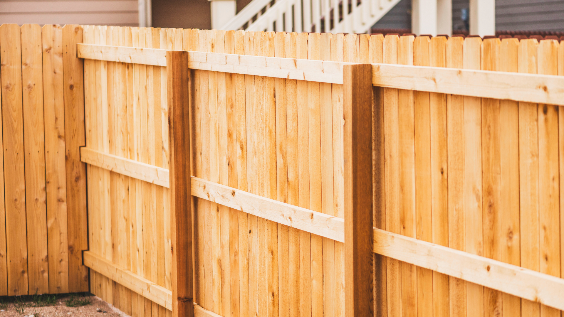 A wooden fence in front of a house